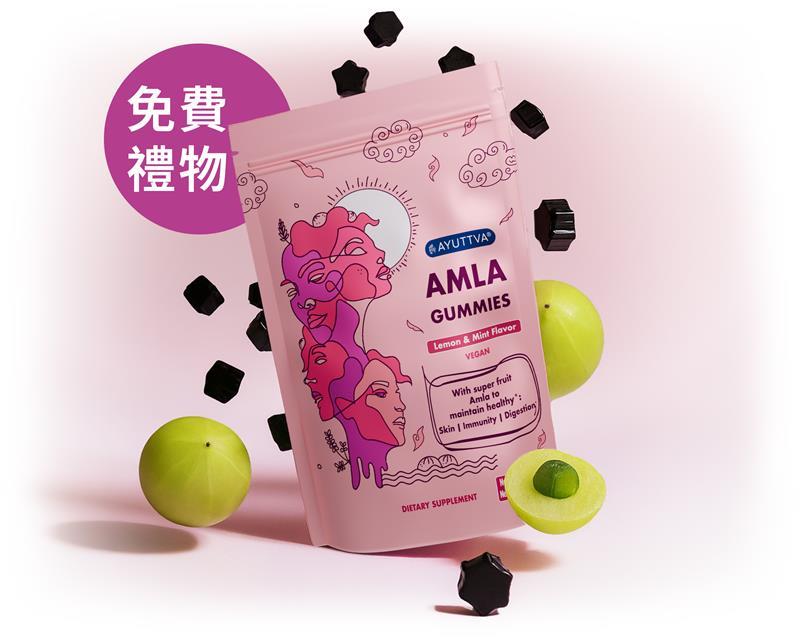 Amla 軟糖包裝，作為免費禮物，周圍有黑色軟糖與印度餘甘子。