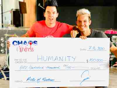 Two men holding up a large check