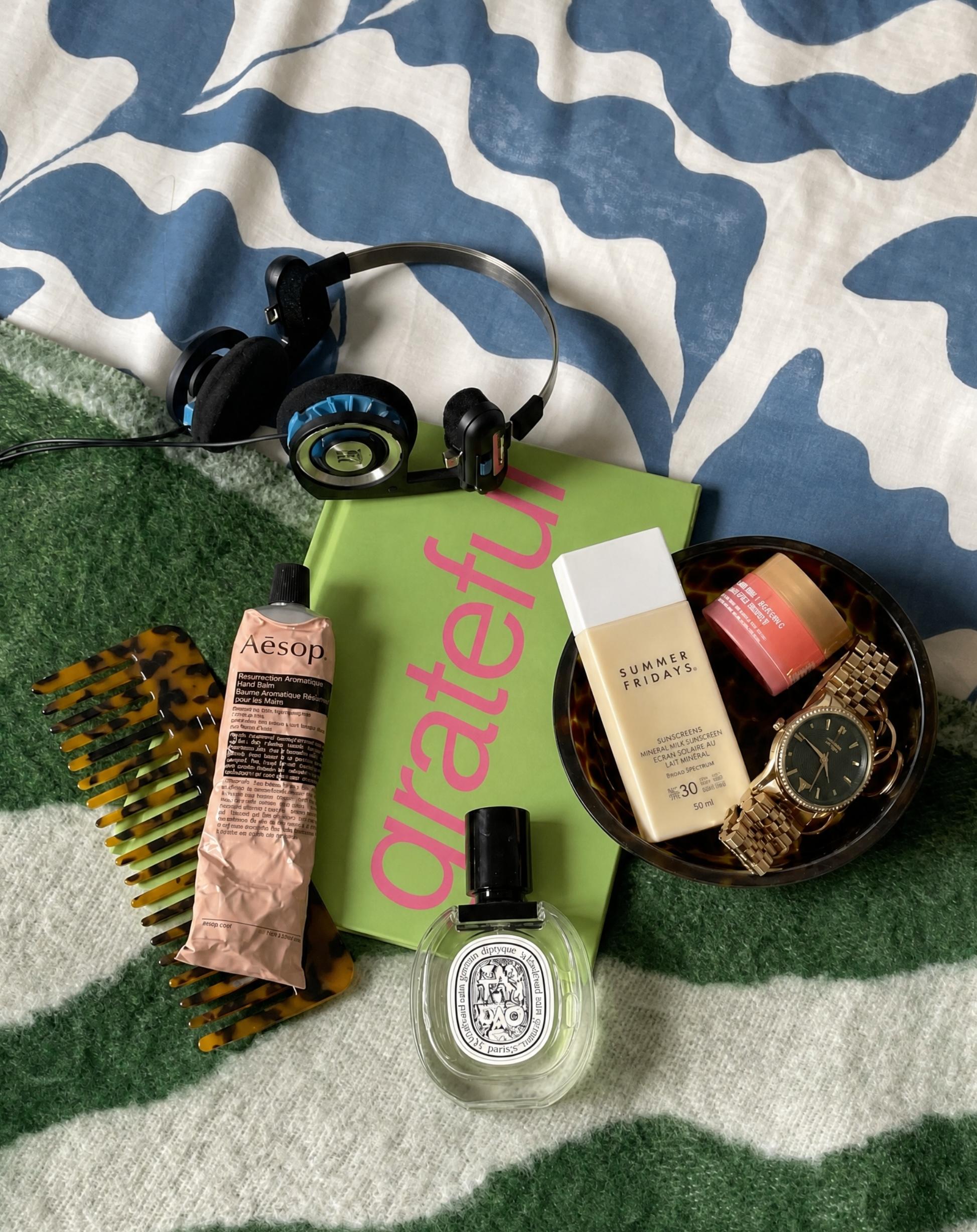 journal with headphones on bed