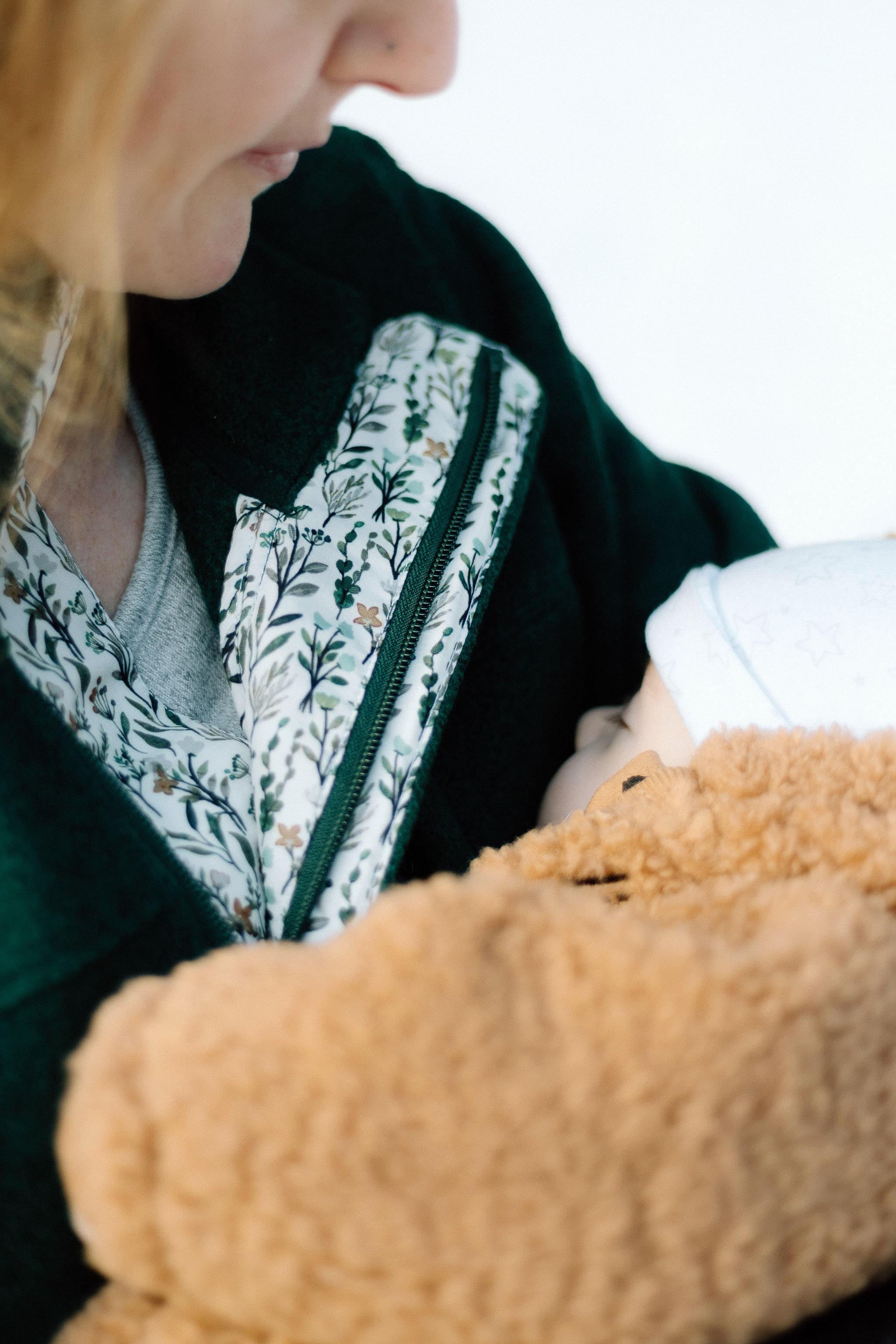Close up of mom and baby nursing. Mom is wearing All Phases Fleece