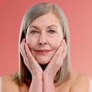 Women touching face after applying blavana face pommade