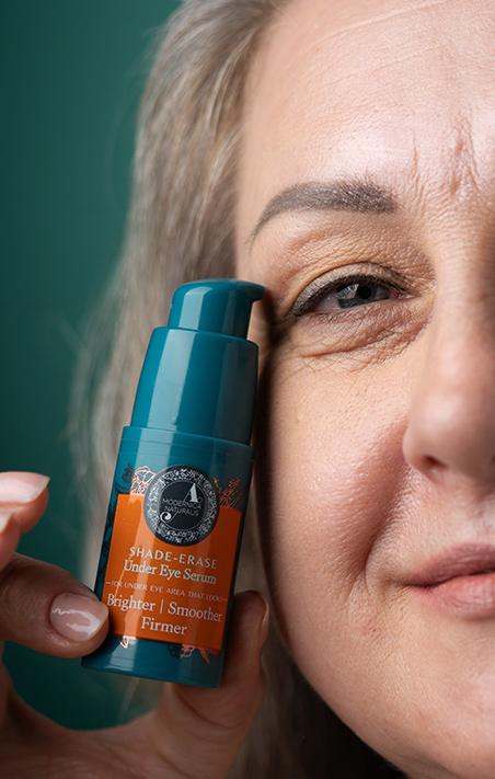 mature beautiful woman with shade erase under eye serum bottle