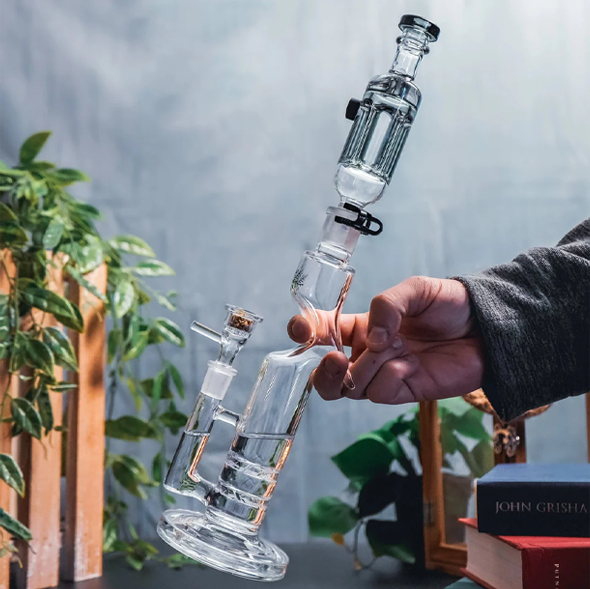 A person holding a bong in hand