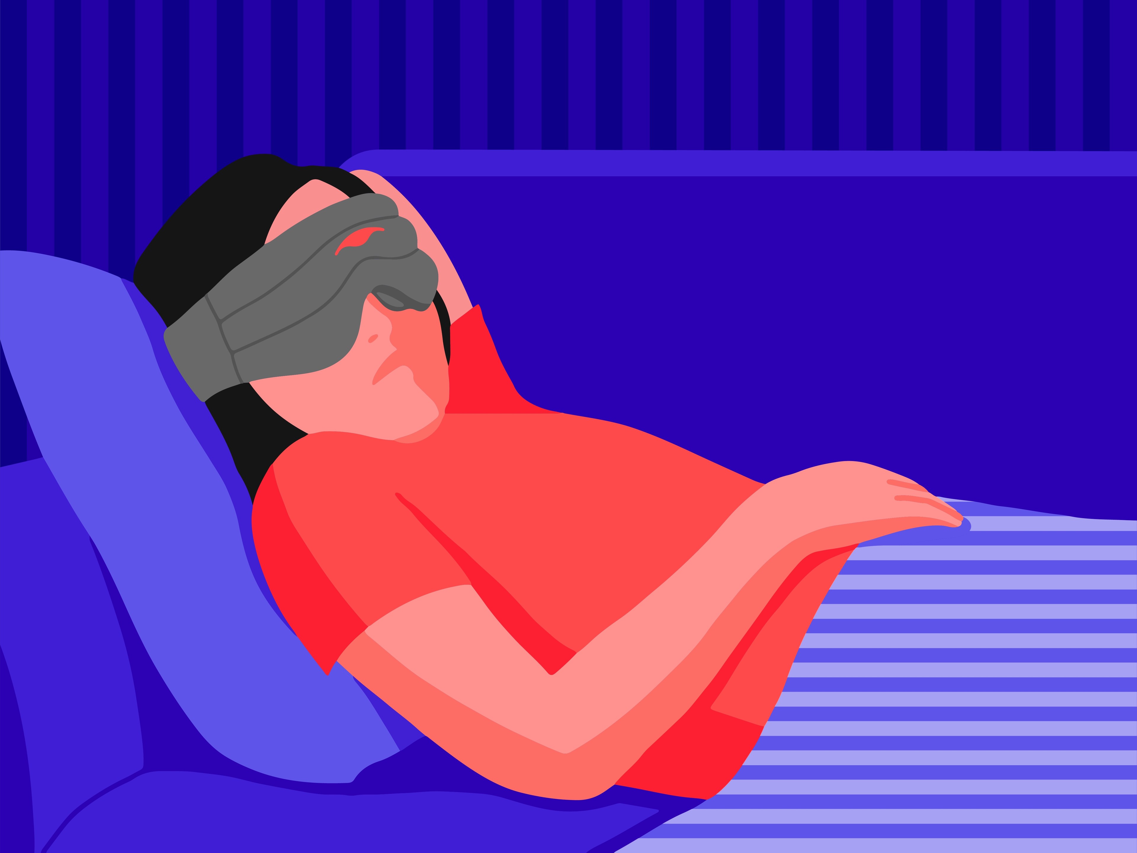 A girl wearing a weighted sleep mask while napping on a couch.