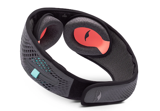 The inner portion of an adjustable sleep mask for light sleepers with headphones with C-shaped eye cups attached.