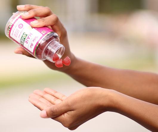 Black woman taking a vitamin