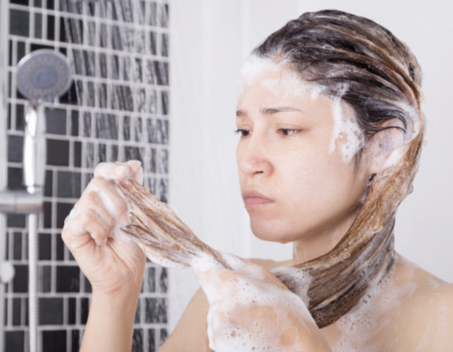 woman using chemical-based hair shampoo