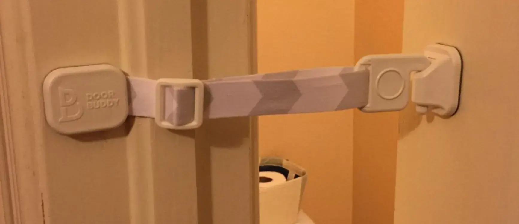 Door Buddy Door Strap installed on a door, holding it open just enough for a cat to pass through — no cutting or drilling required