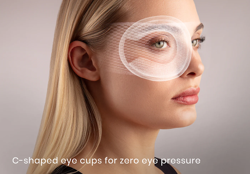 A girl with an outline of a C-shaped eye cup surrounding her eye of the best eye mask for meditation.
