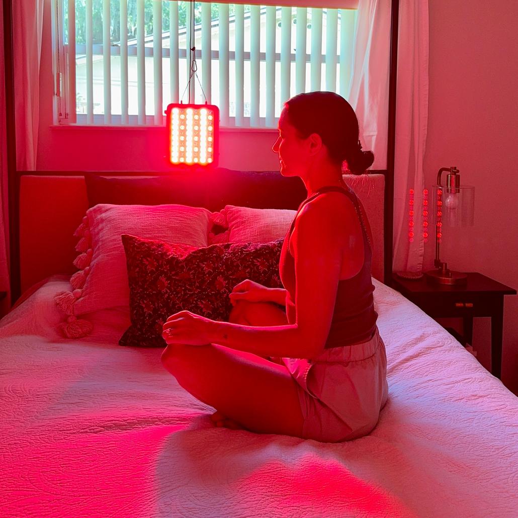 Relaxed woman enjoying her red light therapy session at home