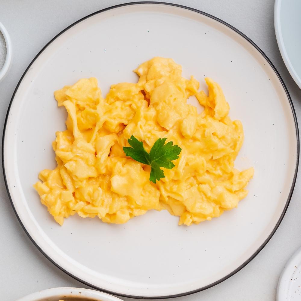Scrambled eggs, Omelette. Breakfast with pan-fried eggs
