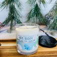 a white cinnamon vanilla candle with a narwhal on a christmas background. Bye buddy hope you find your dad