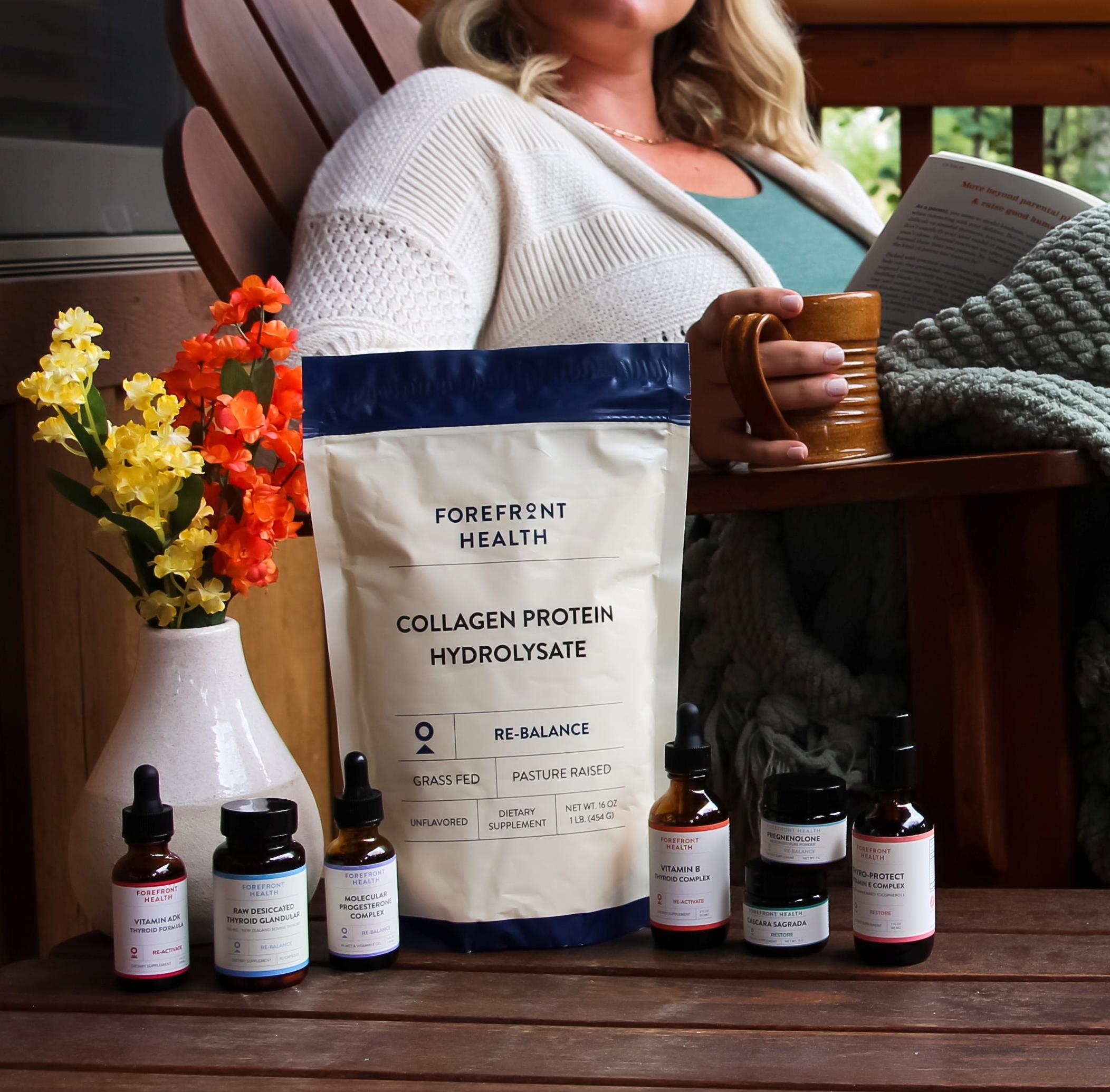 Relaxed woman sitting on the porch with her supplements nearby, sipping coffee and reading a book