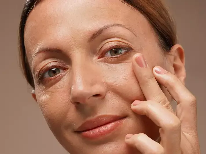 A woman looking happy using the product