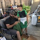 A dad with his son who is wearing the diaper that came in the Deluxe Dutch Oven Kit.