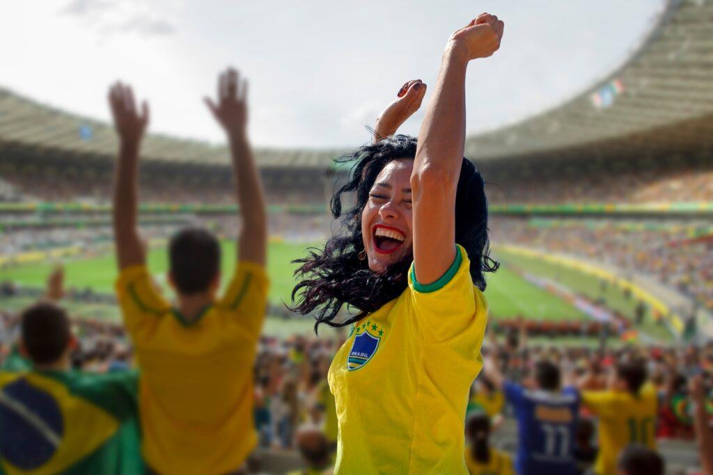 Woman celebrating goal in soccer Brazil, at the football stadium