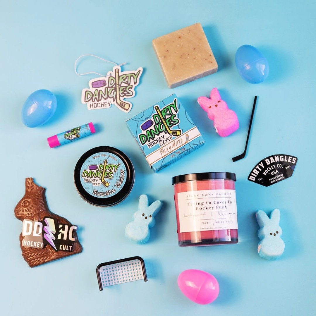 Assorted dirty dangles products on a blue background with blue and pink easter eggs and blue and pink peeps bunnies