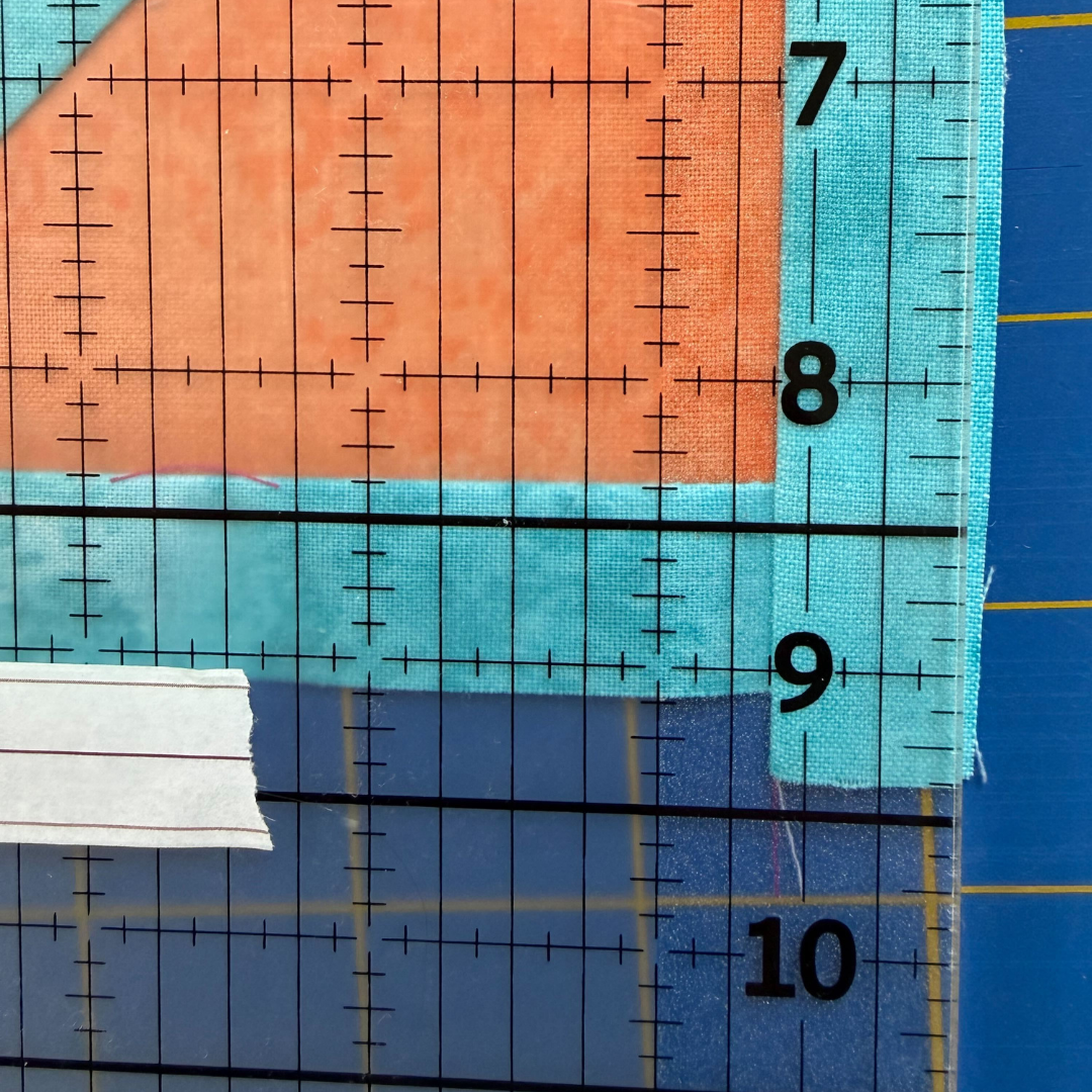 Edge of quilt block past washi tape line on the horizontal side.