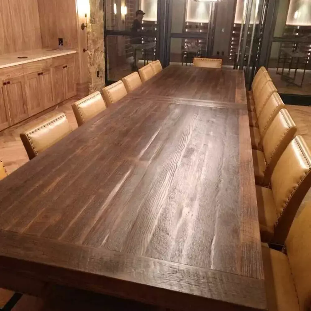 Reclaimed wood conference table with tan leather chairs in elegant meeting space