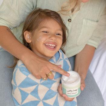 Little girl being applied with AOO by her mama