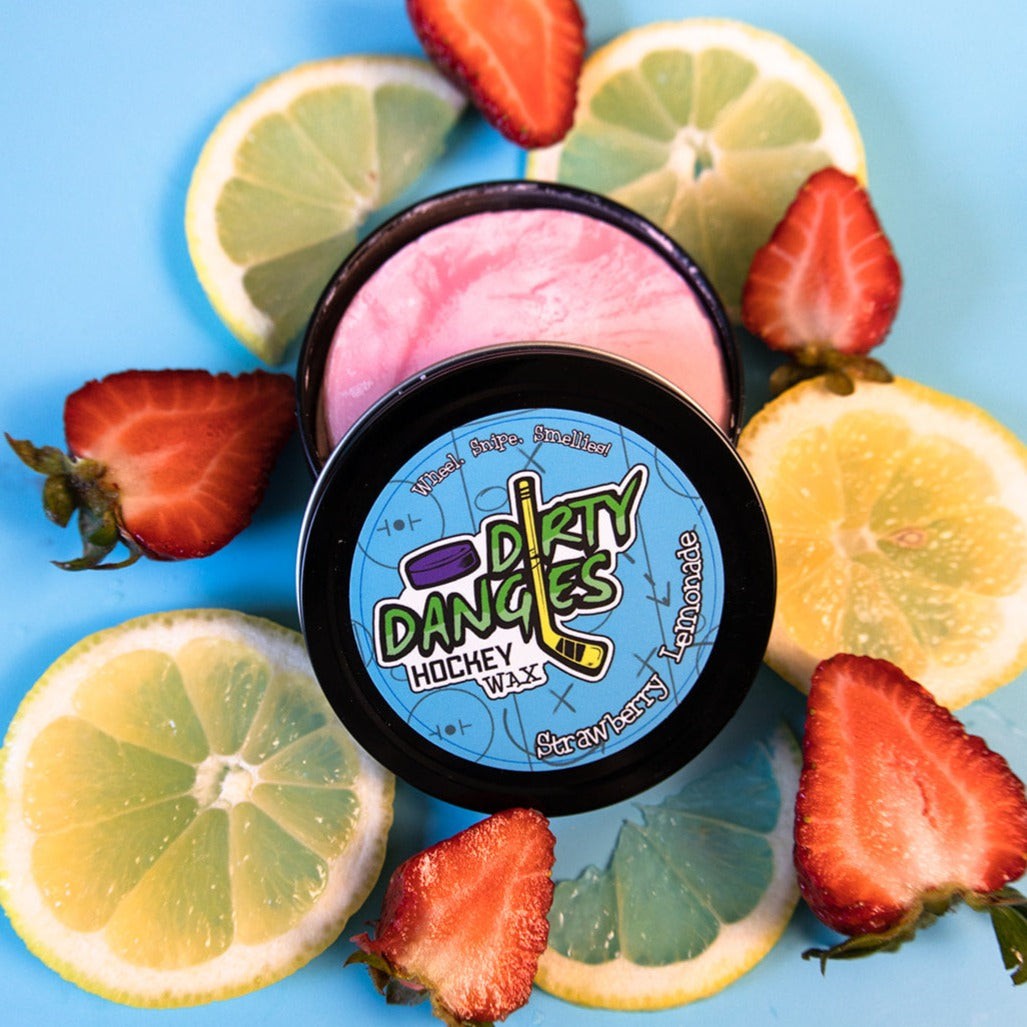 A tin of dirty dangles hockey stick wax strawberry lemonade scent. Pink color on a blue background with lemons and strawberries.