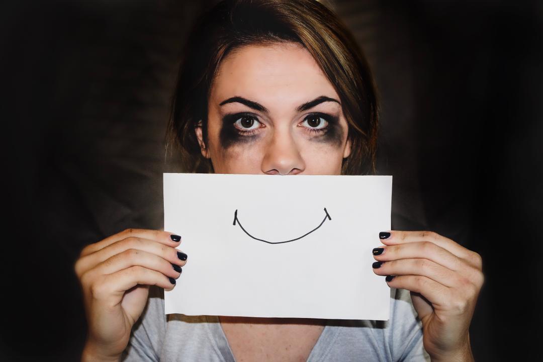 Woman with a happy face sign