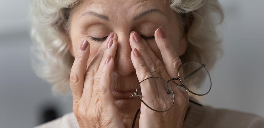 Mature woman rubbing her eyes