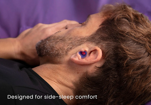 A man sleeping on his side wearing the best earplugs for sleeping.