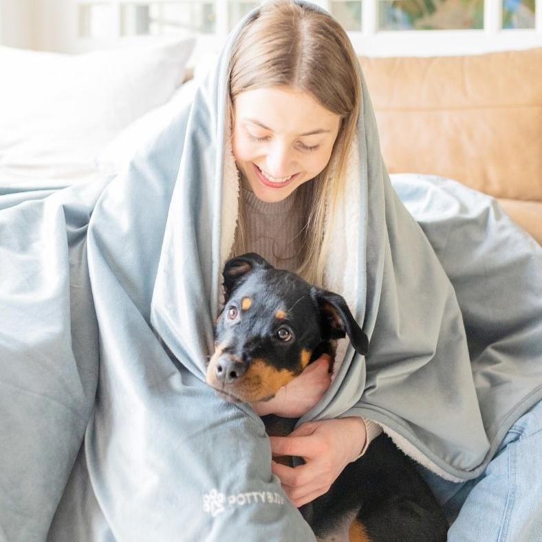 Woman treating labrador puppy