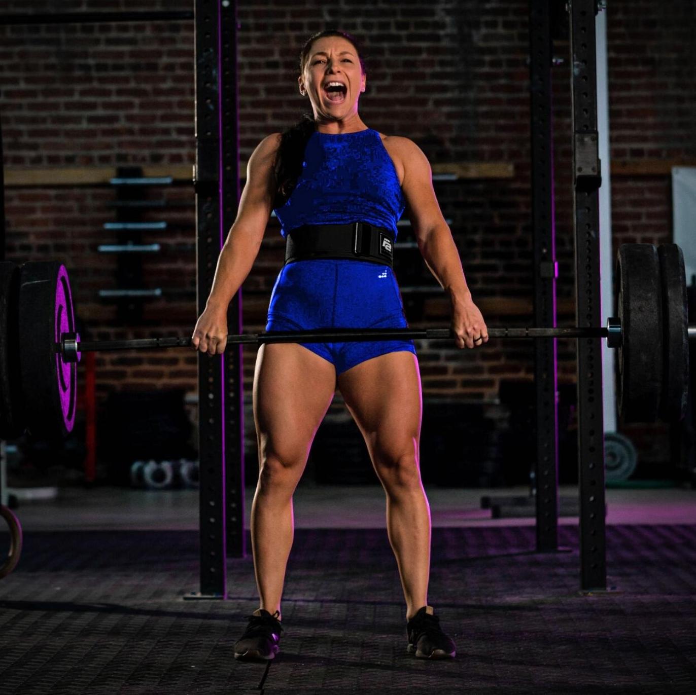 Man squatting with barbell with weights attached