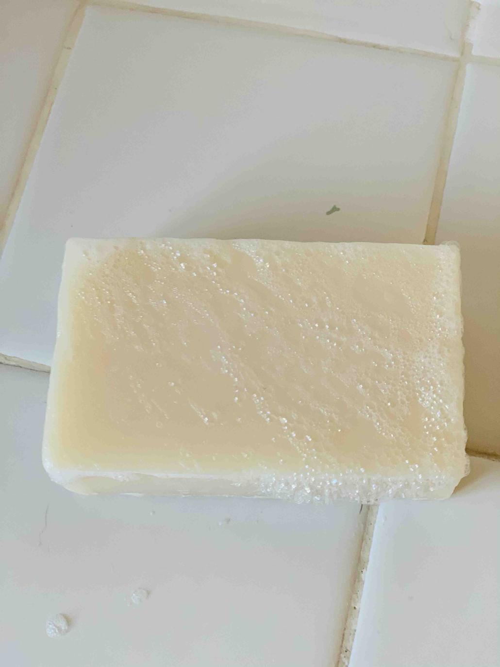 picture of white tea and ginger soap bar on white tile