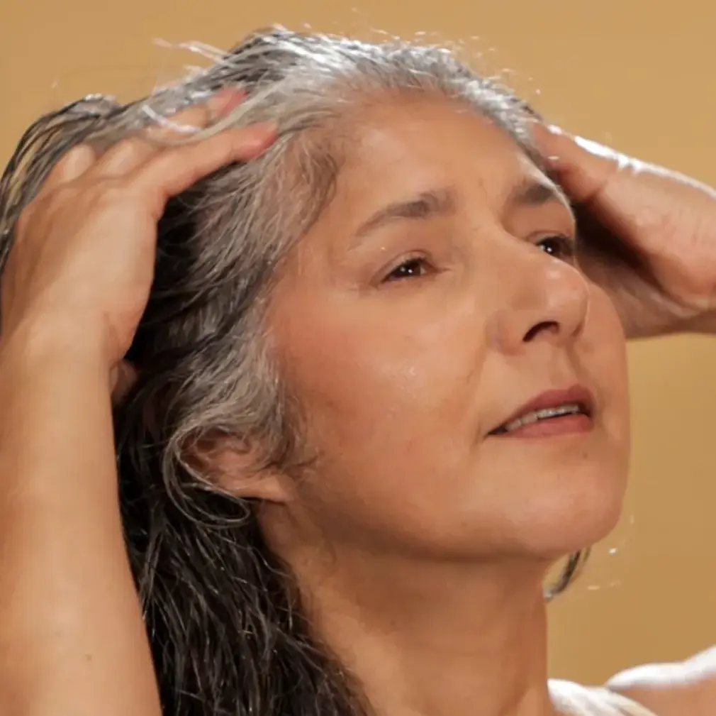Spread the oil with your fingertips using slow, circular motions.