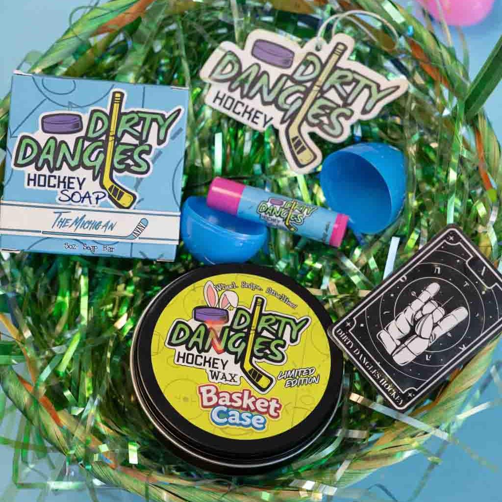 Tin of Dirty Dangles Basket Case marshmallow candy scented hockey wax with Easter eggs and a basket in the background