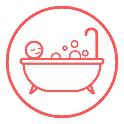 A person bathing in a bathtub surrounded by bubbles