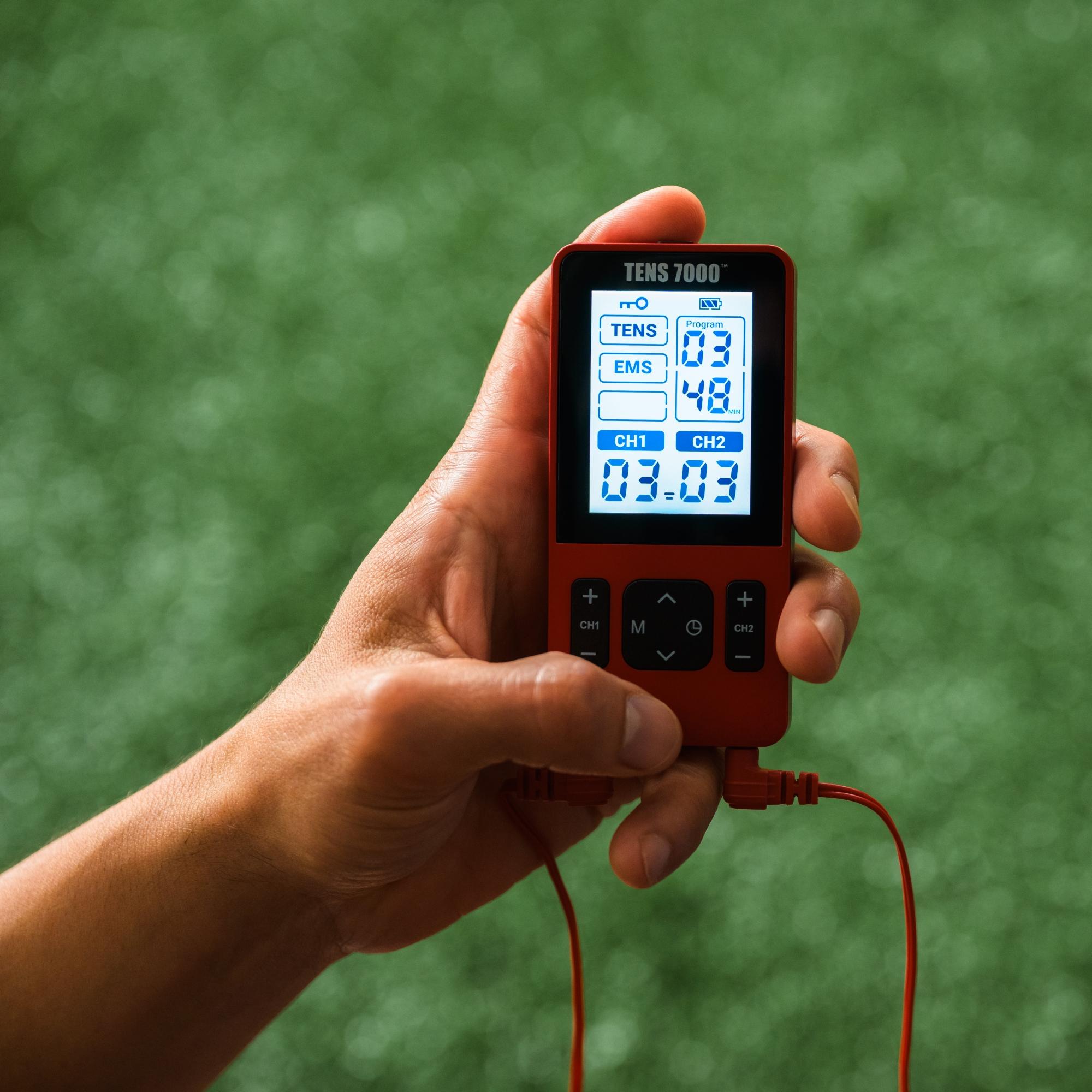 A focused shot of the TENS 7000 Sports TENS Unit turned on