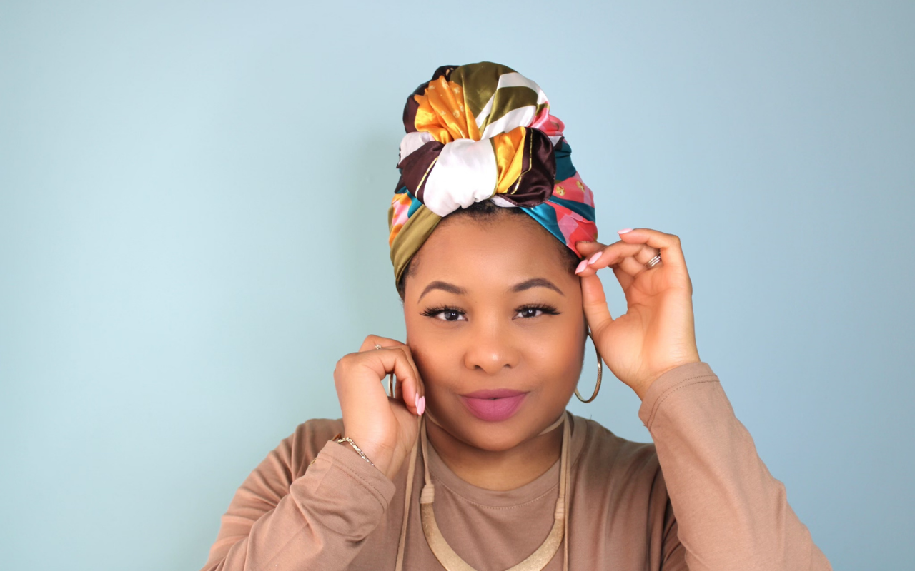 african american woman wearing a satin scarf to protect her natural hair and scalp