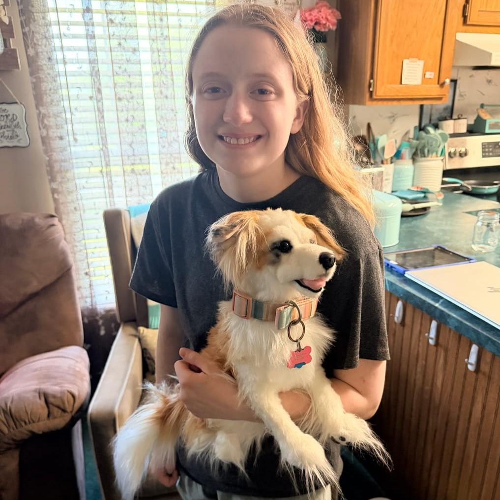 customer holding a custom pet plush of her pet Max