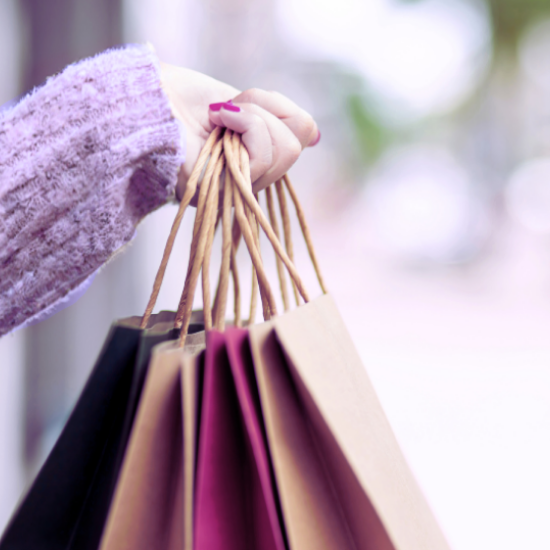 hand holding several shopping bags