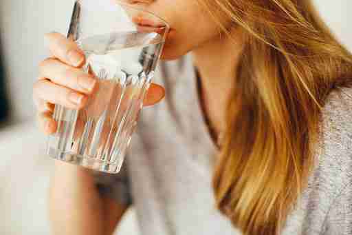woman drinking water staying hydrated