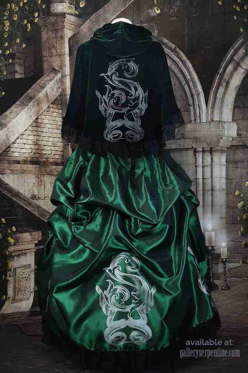 BACK VIEW OF THE NEW DELUXE SLYTHERING CAPE IN DARK GREEN VELVET WORN OVER A MATCHING EMERALD TAFFETA VICTORIAN SKIRT