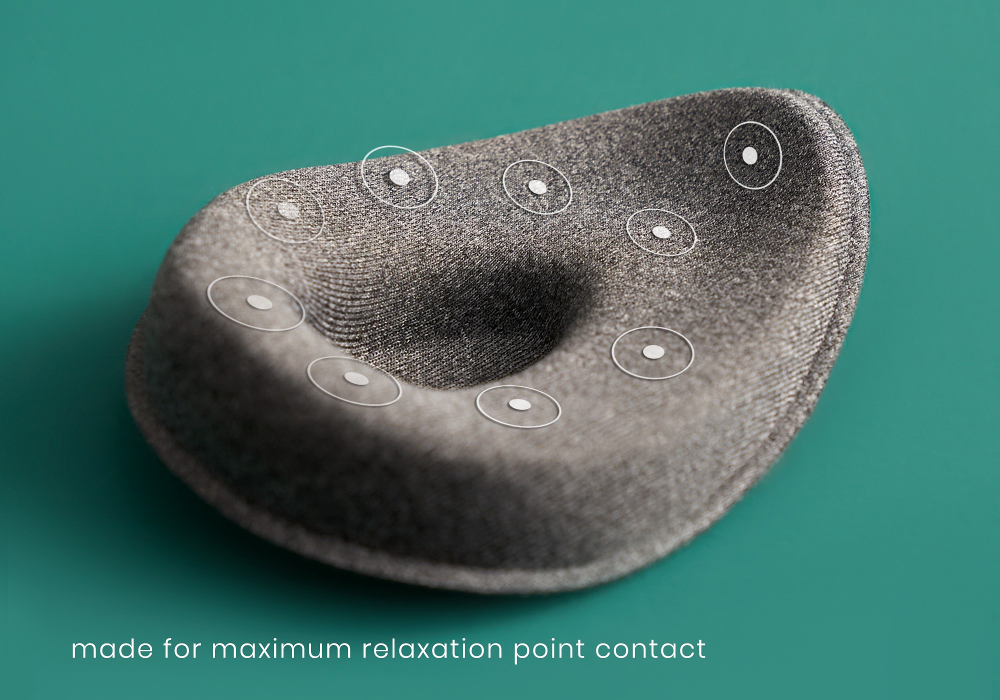 A tapered eye cup of a weighted sleep mask with an indentation in its center and white circles to indicate pressure points.