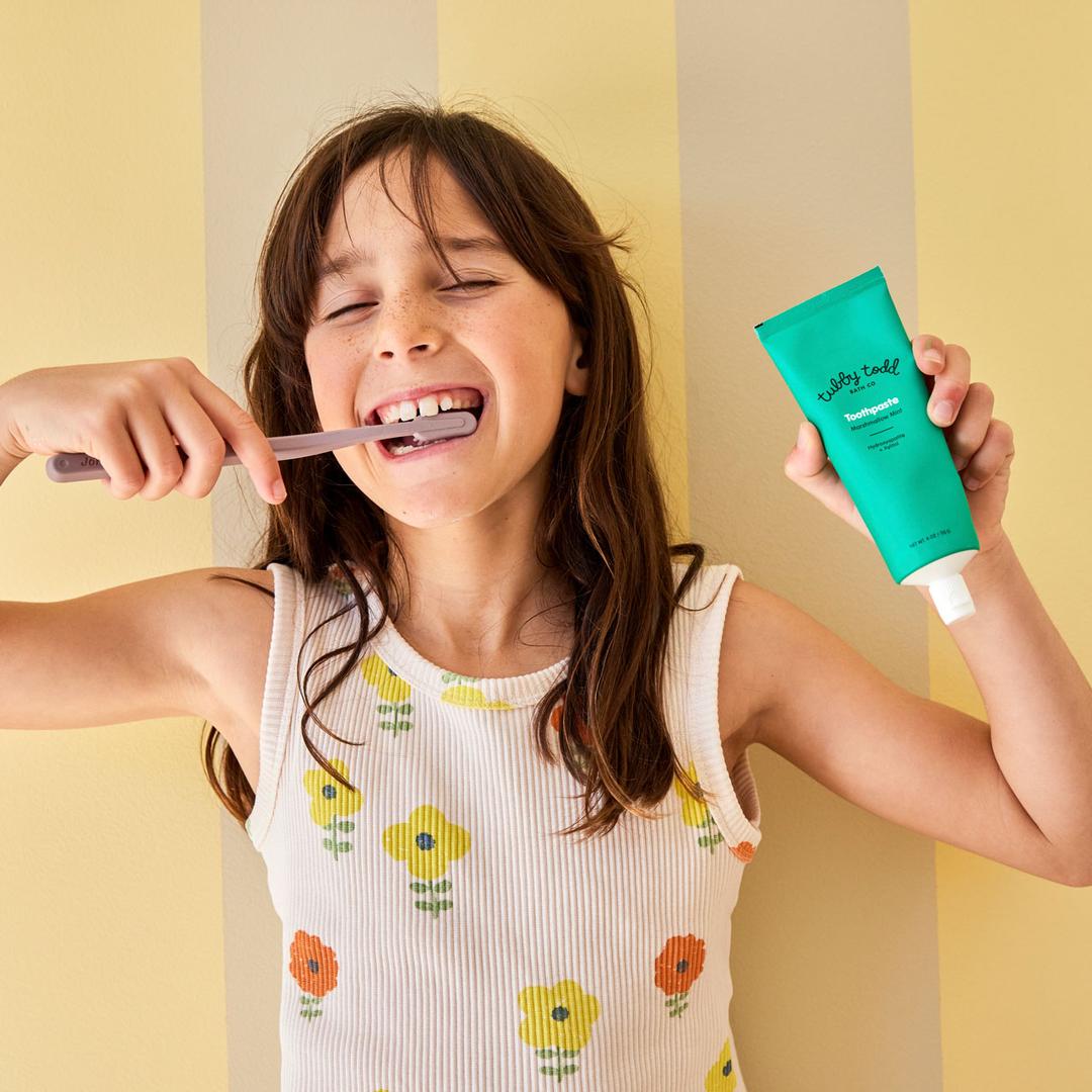 Young girl brushing her teeth