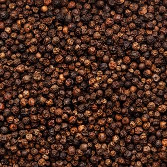 Close-up of densely packed black peppercorns.