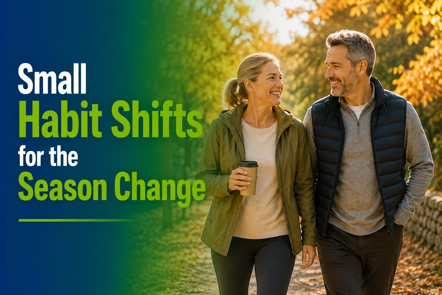 A smiling couple walks hand-in-hand through a sunlit autumn park, the woman in an olive green jacket holding a disposable coffee cup.