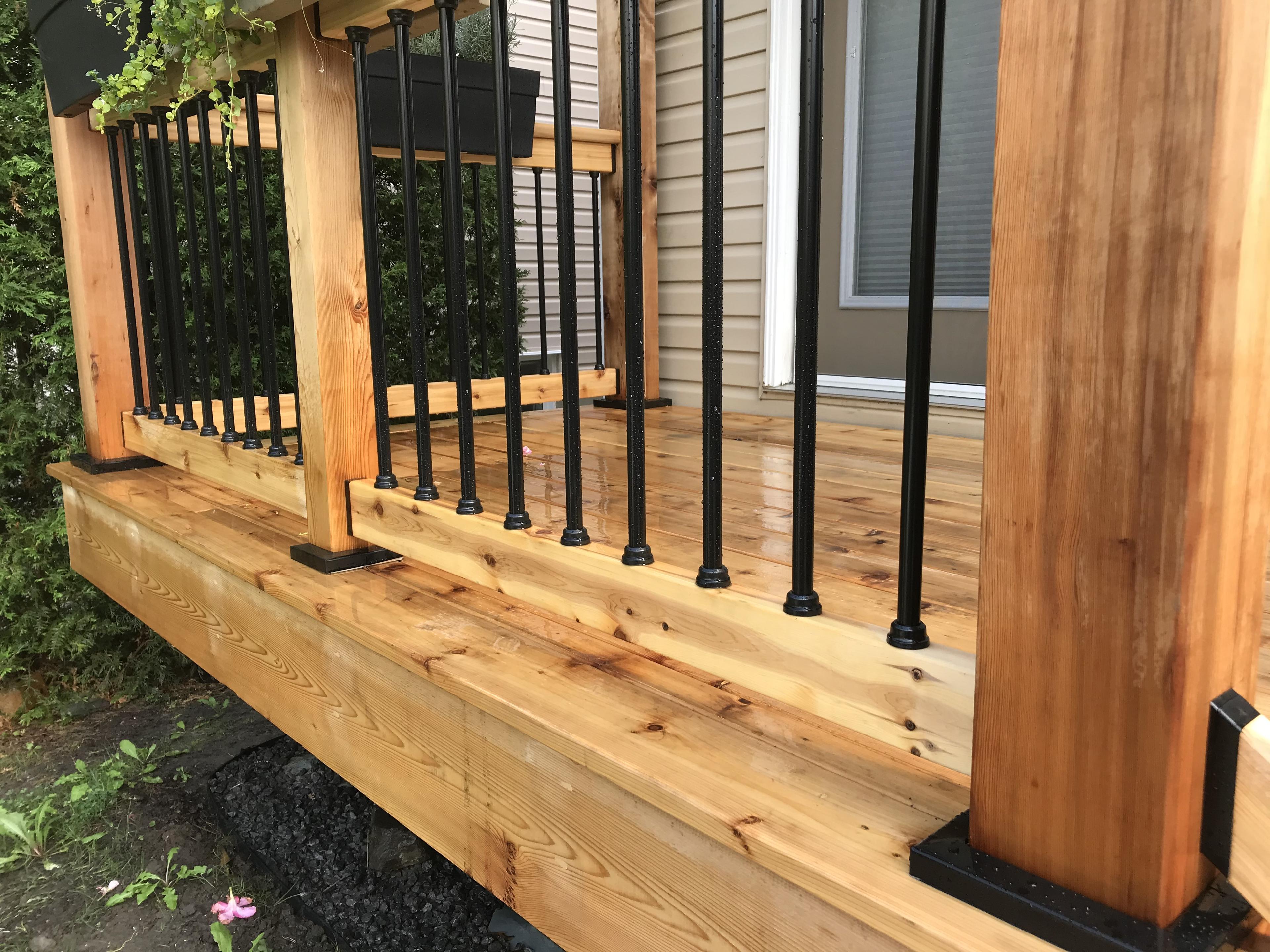 snap'n lock balusters installed on a wooden railing connected by shadow rail connectors