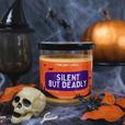 An orange silent but deadly stank away halloween candle on a spooky halloween background