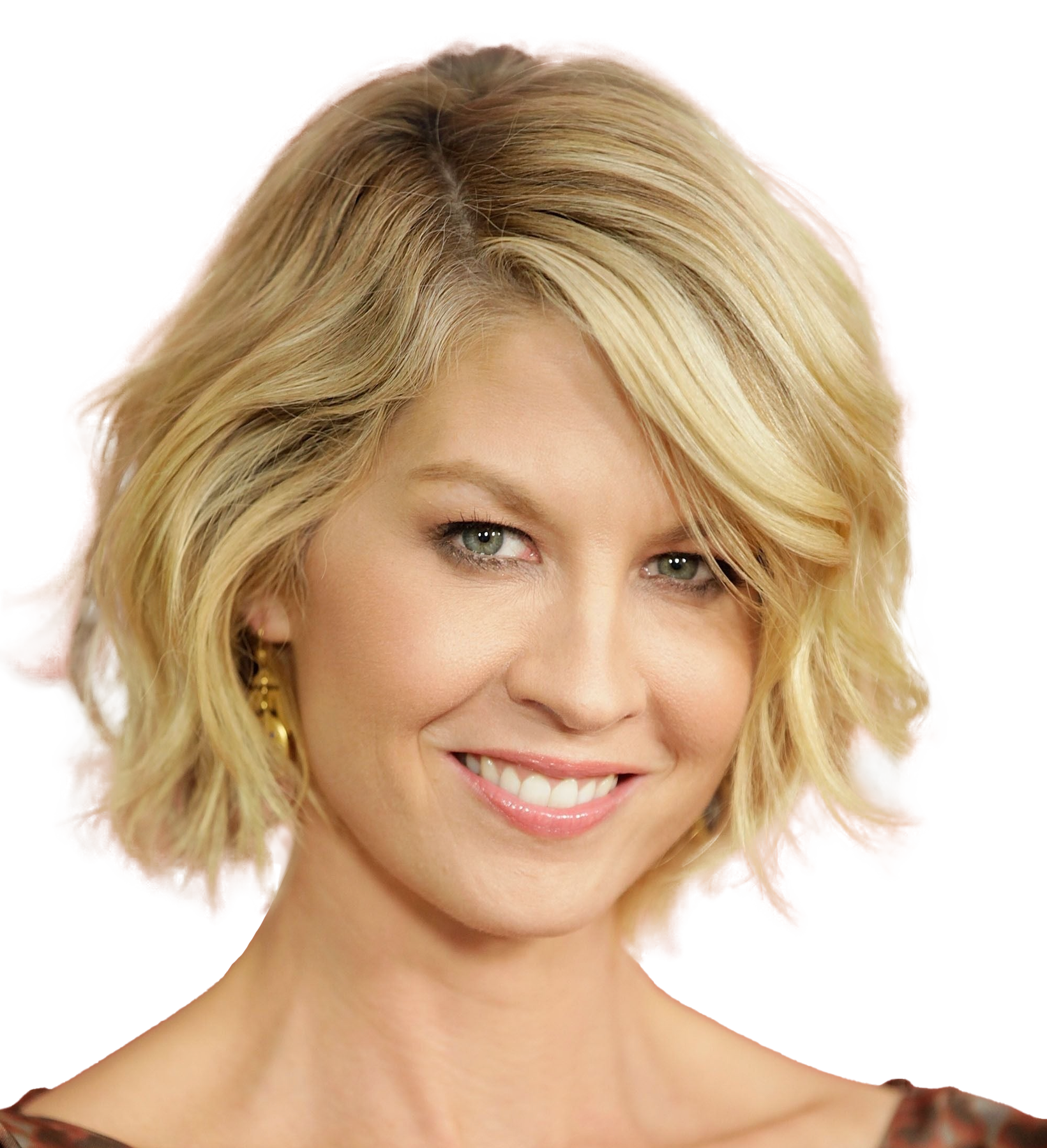 actress Jenna Elfman smiling, on a white background