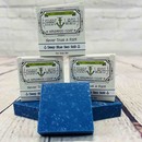 Picture of a box of Shart Wash Natural Handmade Bar Soap Deep Blue Sea Salt scent sitting on a blue bar of soap with a wood background