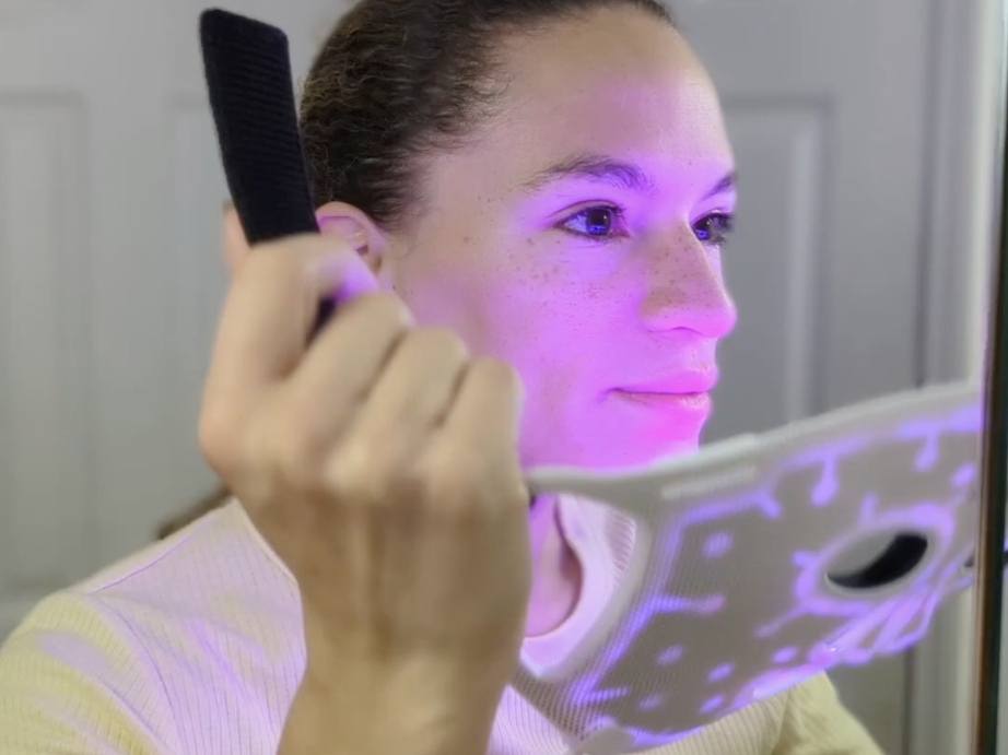 woman putting led mask on