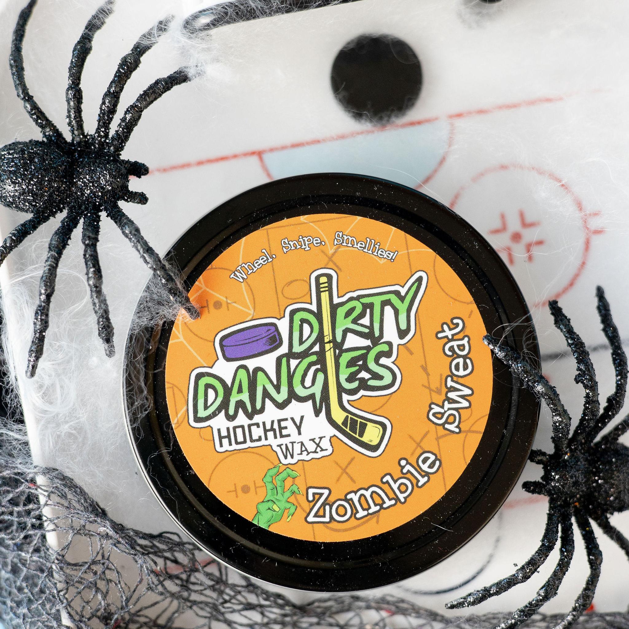 A tin of Halloween dirty dangles hockey zombie sweat pumpkin spice stick wax on a spooky background with spiders